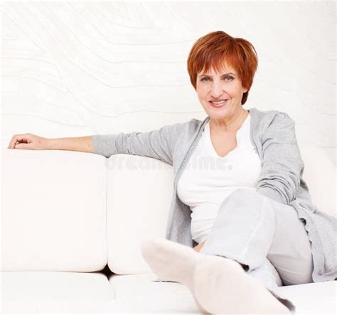 happy mature woman on sofa stock image image of life 32812357