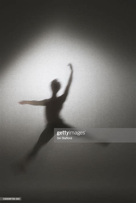 Silhouette Of Male Ballet Dancer In Mid Air Leap High Res Stock Photo