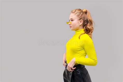 portrait an attractive stunning cheerful slender girl posing in bright yellow stock image
