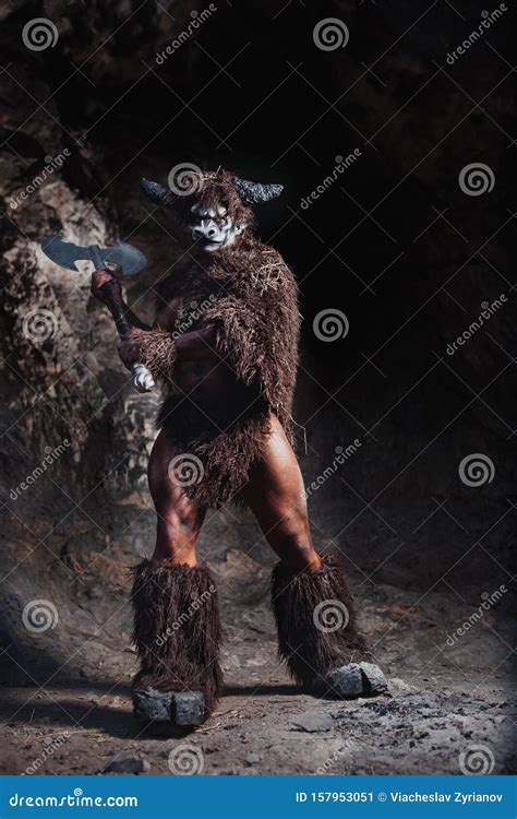 Mythological Minotaur Half Bull Half Man Stands In A Rock Cave In An
