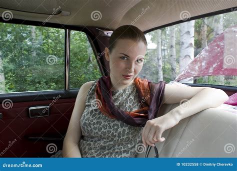 Beautiful Girl On Back Sitting Of The Car Royalty Free Stock Photos