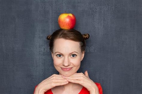 portrait of cute happy smiling girl with red apple on head stock image image of garden