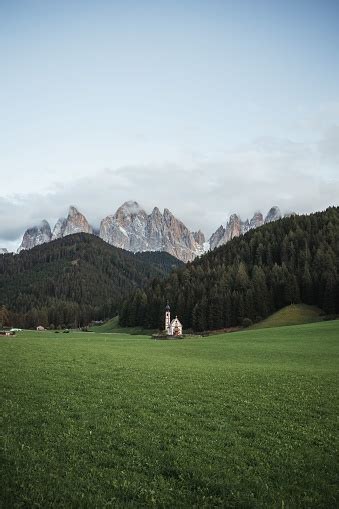 Sunny Landscape Of Dolomite Alps With St Johann Church And Mountains In