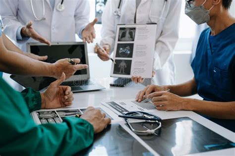 Medical Team Having A Meeting With Doctors In White Lab Coats And