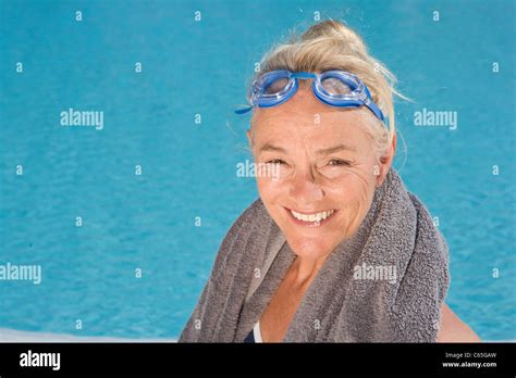 Mature Woman By Swimming Pool Stock Photo Alamy