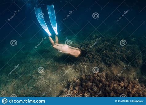 Naked Sporty Woman With Freediving Fins Dive In Ocean Stock Photo