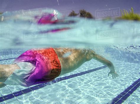 Close Up Of A Boy Swimming Underwater In A Swimming Pool Stock Photo