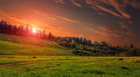 Rural Landscape With A Hill Green Meadow Under Sunset Colorful Sky