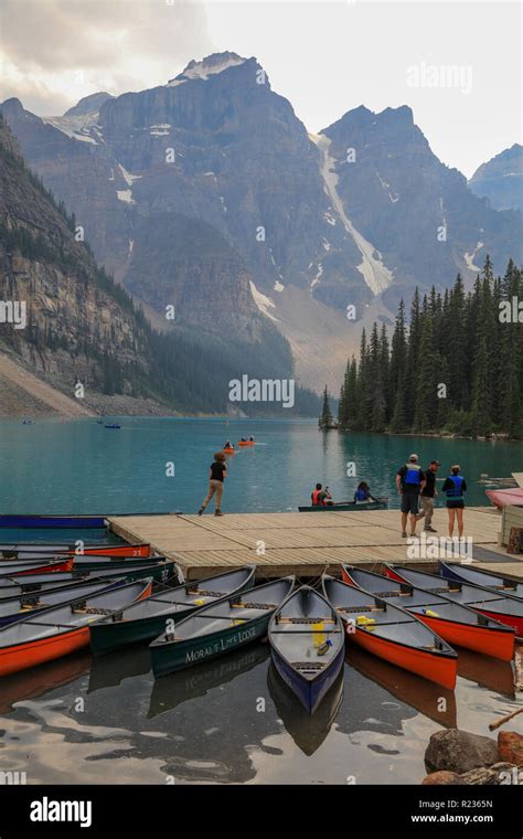 Canoes And People At The Dock On Moraine Lake In The Canadian Rockies