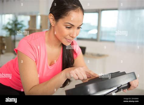 Woman Checking Settings Of A Step Machine Stock Photo Alamy