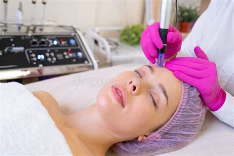 Woman In A Spa Salon On Cosmetic Procedures For Facial Care Beautician Makes Skin Care