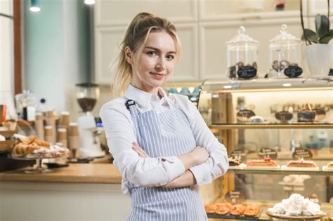 What does it take to launch an online café? Portrait of a female owner standing in her coffee shop ...