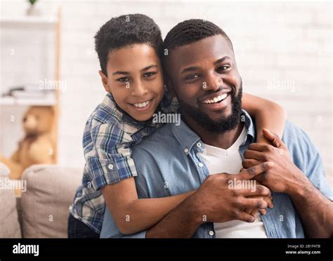 Closeup Portrait Of Happy Black Father And Son Posing At Home Stock