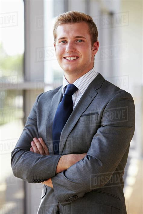 Portrait Of A Young Smiling Professional Man Arms Crossed Stock