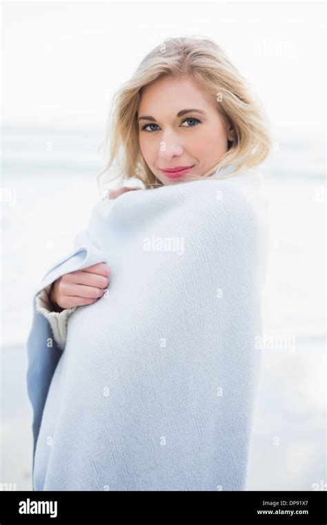 Pleased Blonde Woman Warming Herself In A Blanket Stock Photo Alamy