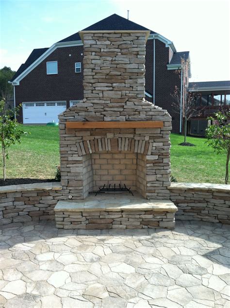 Back Yard Patio Area With Brick Pavers Fireplace And Landscaping