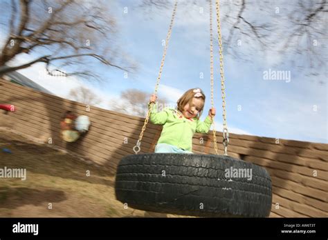 Happy Toddler Outdoors On Tire Swing Stock Photo Alamy