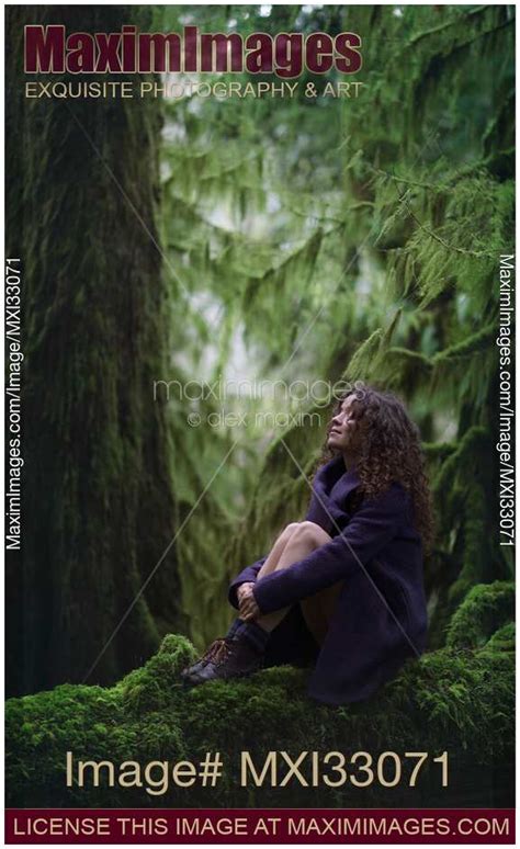Photo Of Woman With A Dreamy Expression Sitting On A Mossy Tree Trunk In Ancient Green Forest