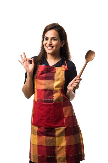 Premium Photo Indian Or Asian Woman Chef Wearing Apron And Holding Pan And Spatula While