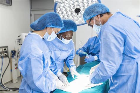 Medical Team Performing Operation Group Of Surgeon At Work In