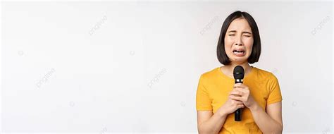 Heartbroken Asian Girl Sings Into Mic Grimacing Asian Entrepreneur