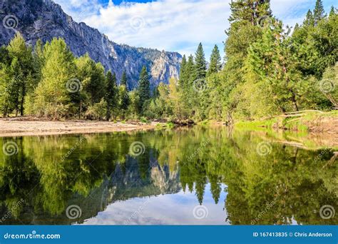 Trees Reflect From Both Sides Of The Merced River In Yosemite National
