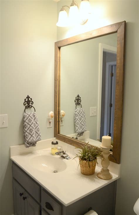 Custom frames designed for existing bathroom mirrors. Guest bathroom update - Stained wood framed bathroom mirror
