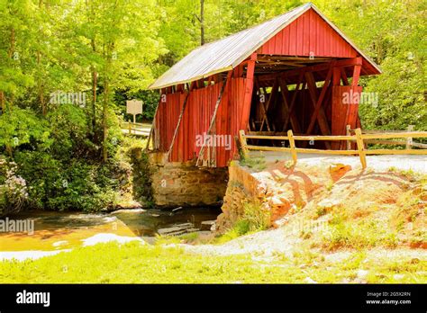 Red Covered Bridge In The Water Stock Photo Alamy