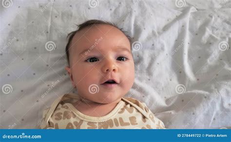 Cute Newborn Baby Boy On A White Bed Close Up Shot Child S Emotions