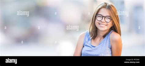 Portrait Of Beautiful Young Smiling Teen Girl With Glasses And White