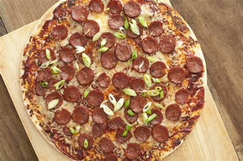 Perfect for those with dairy allergies. Whole pepperoni pizza with shallots - Free Stock Image