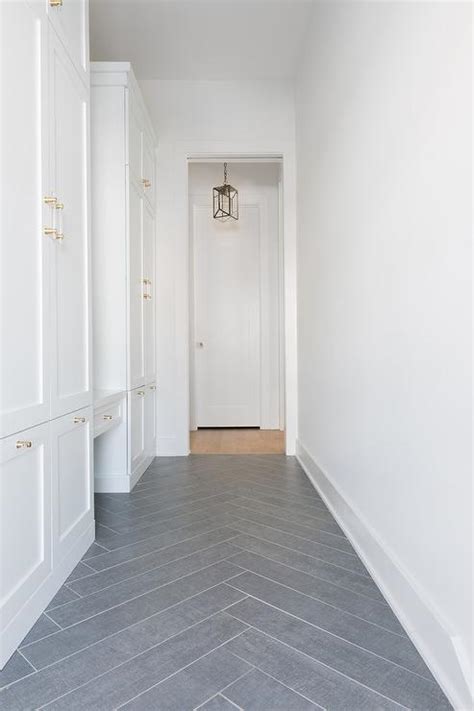 Gray Slate Herringbone Pattern Mudroom Floors With White Cabinets