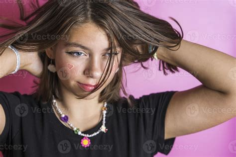 Portrait Of A Beautiful Caucasian Girl Shaking Her Hair Posing On A Pink Background 18789106