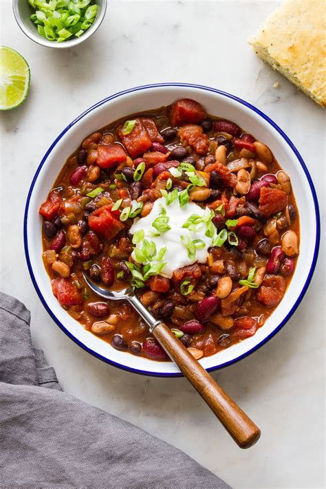 A Bowl Of Chili With Beans Sour Cream And Lettuce On The Side