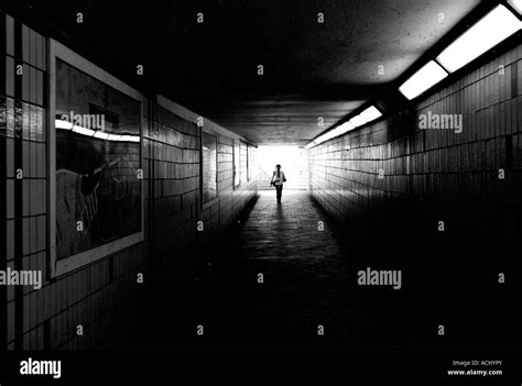 Woman Walking Towards Light Tunnel Black And White Stock Photos