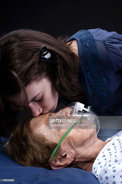 Teenage Girl Kissing Her Grandmother At The Hospital High Res Stock