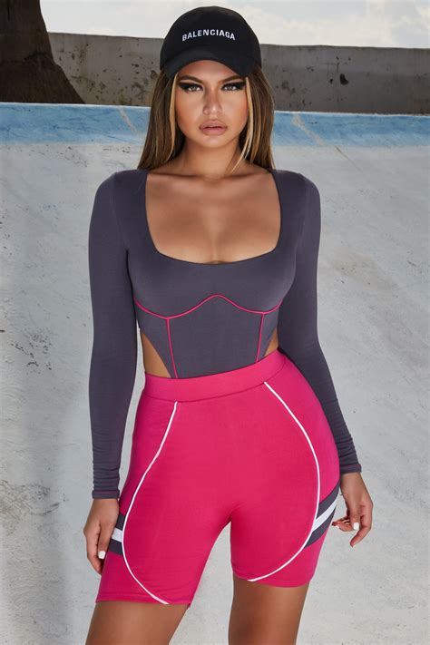 Demi Rose Wears Grey Bodysuit Tucked Into Hot Pink Cycling Shorts