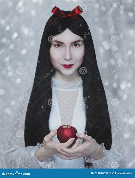 Young Pretty Woman With White Skin And Red Lips Is Keeping The Red Poisoned Applesnow White