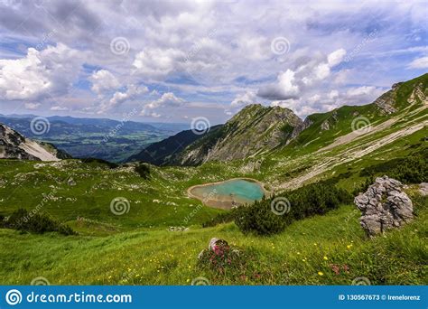 Scenic Mountain Panorama With Green Meadows And Idyllic Lake Oberer