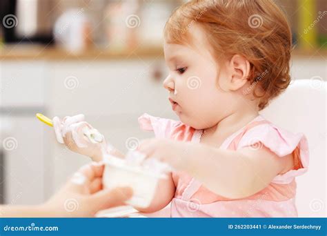 Feeds Baby With A Spoon Porridge A Little Girl Eats Food Himself