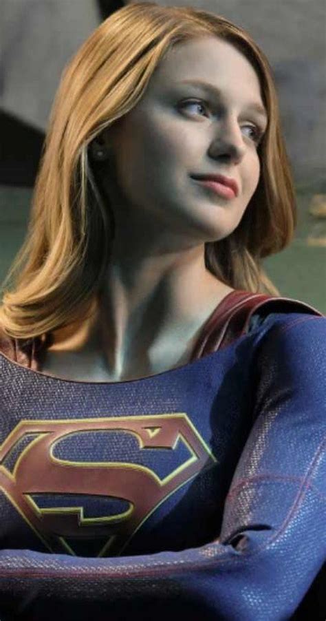 A Close Up Of A Person Wearing A Superman Costume With Her Arms Crossed