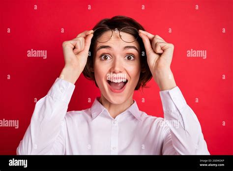 photo portrait of amazed business woman taking off glasses staring surprised isolated vibrant
