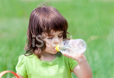 Little Girl Drinking Water From Bottle Stock Photo Royalty Free