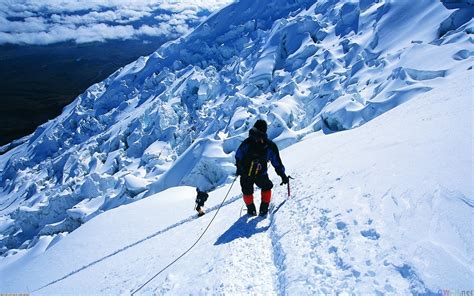 Snow And Ice Mountain Climbing Hikers Descending From Top