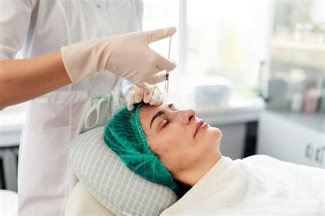 Beautician Injects Rejuvenation Cosmetic Preparations Into The Womanand X27s Forehead