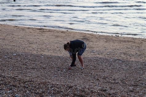 Boy Picking Up Shells On A Beach Stock Photo Image Of Lifestyle Basket