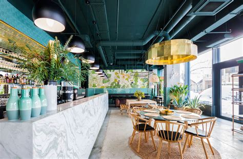 Industrial Style Restaurant With A Greenery Themed Decor