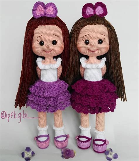 Two Knitted Dolls Standing Next To Each Other