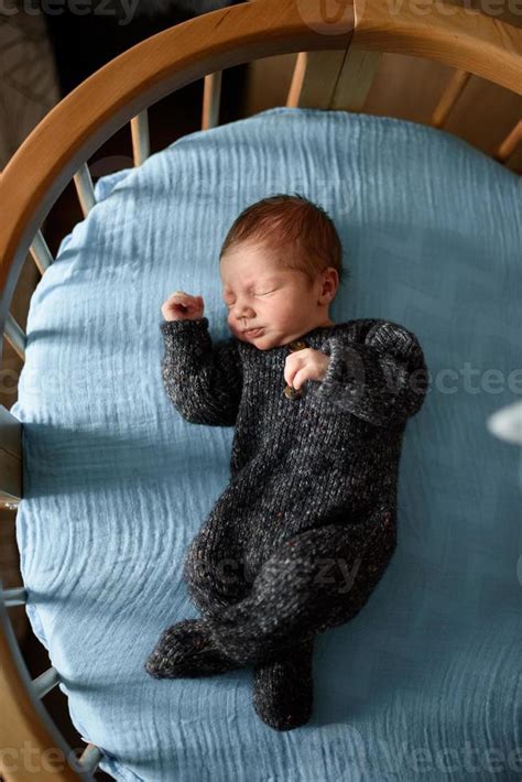A Little Newborn Boy Is Looking At The Window In His Crib A Boy Born