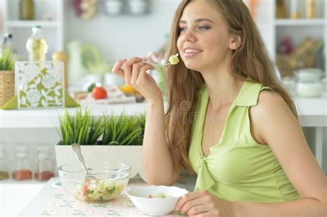 Beautiful Young Woman Eating Salad In Kitchen Stock Photo Image Of